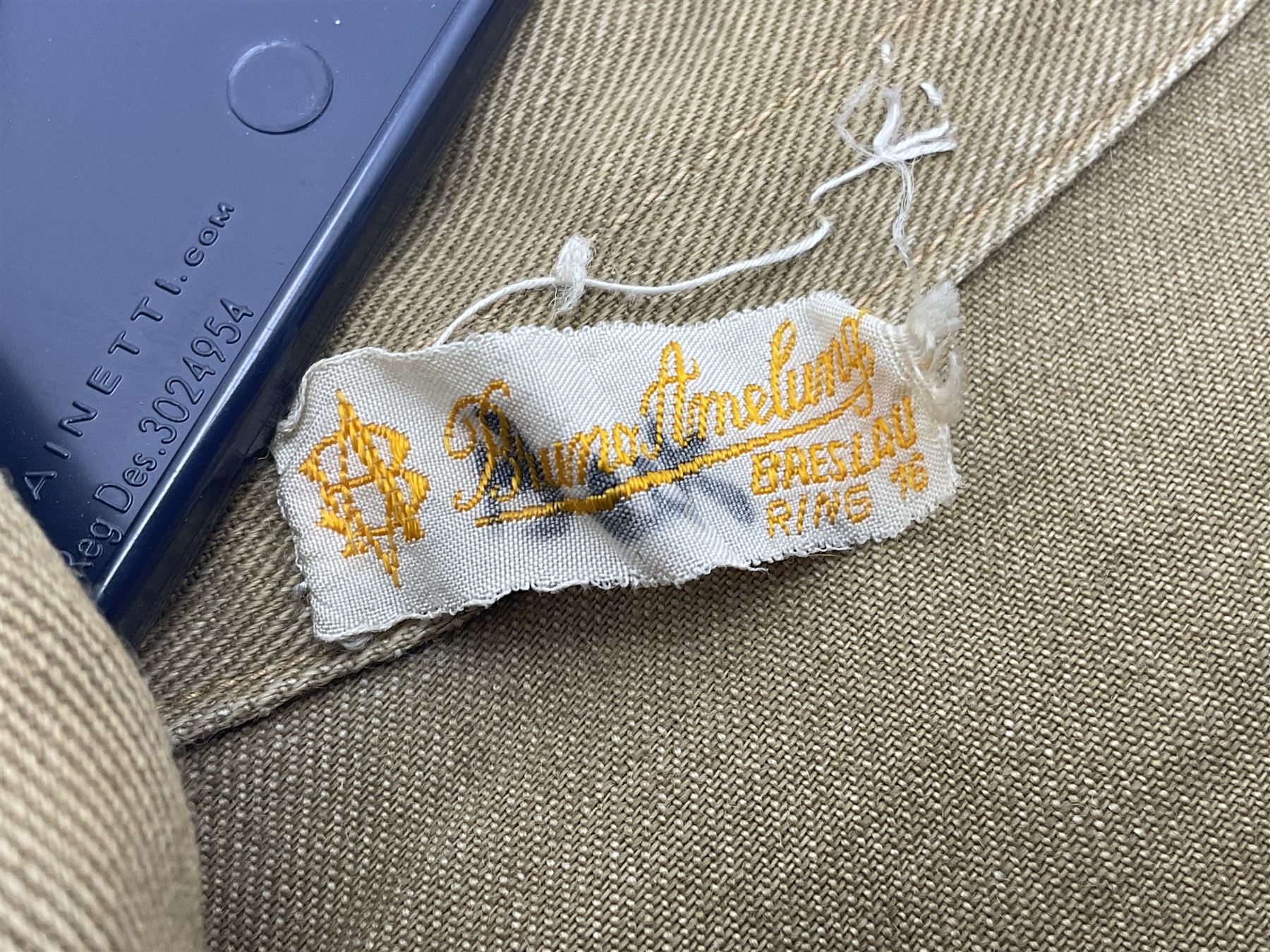 1930s Hitler Youth brown shirt, long length with two pockets, bears triangular badge 'Nord Nordsee'