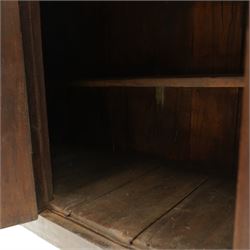 19th century oak hutch cupboard, plank top with moulded cornice and turned finials, panelled front enclosed by two tiers of central double doors with iron hinges and wooden latches, flanked by fixed fielded panels, on stile supports