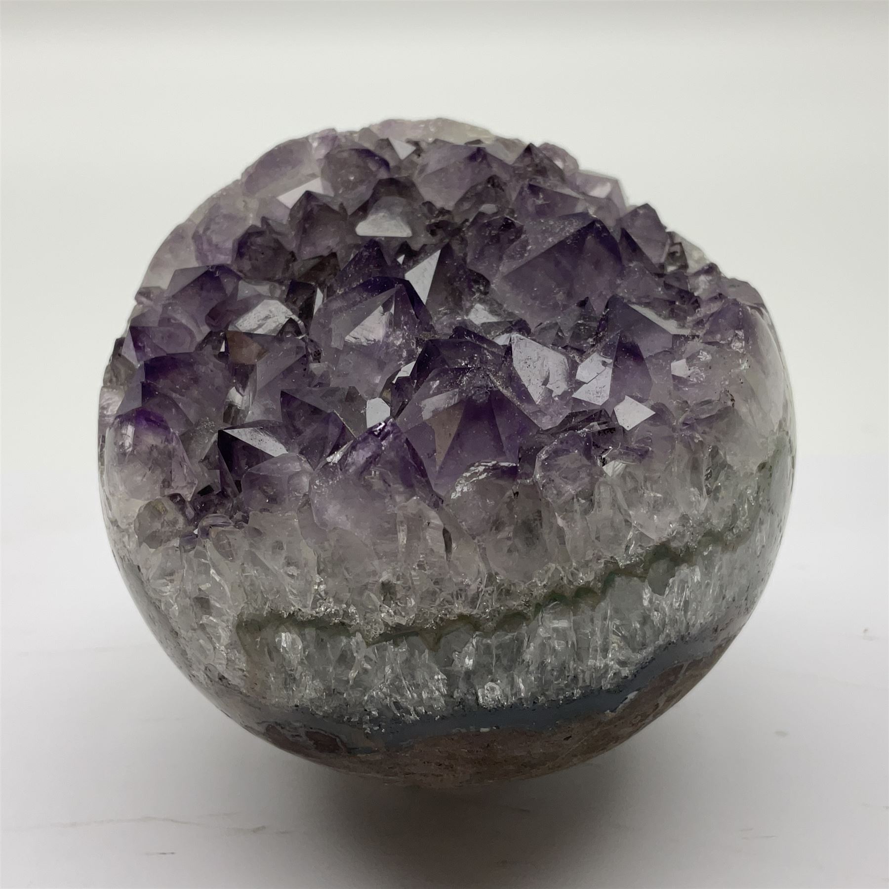 Pair of amethyst geode spheres, with purple crystalline internal formations, D9cm