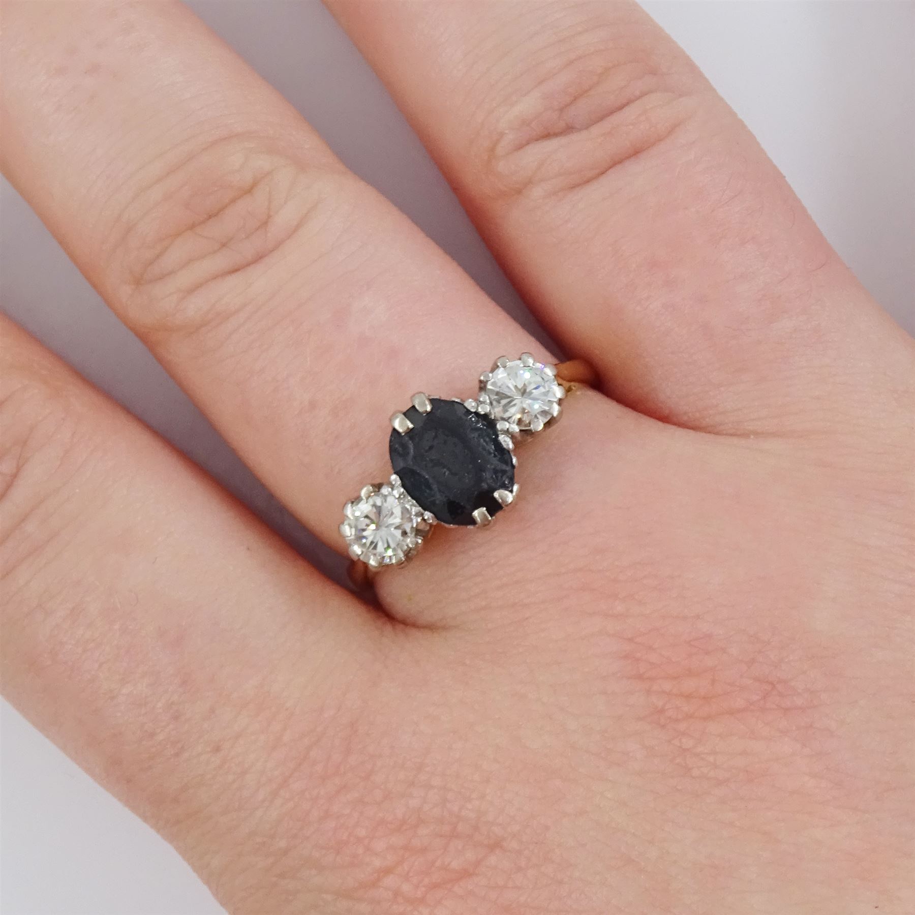 18ct gold sapphire and diamond three stone ring, single oval cut sapphire, with two round brilliant cut diamonds set either side, Sheffield 1987, total diamond weight approx 0.60 carat