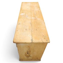 Victorian stripped pine sideboard, rectangular plank top rounded edges, with central cupboard door with shaped panel, flanked by two banks of three graduating drawers with turned knobs, raised on a plinth base 