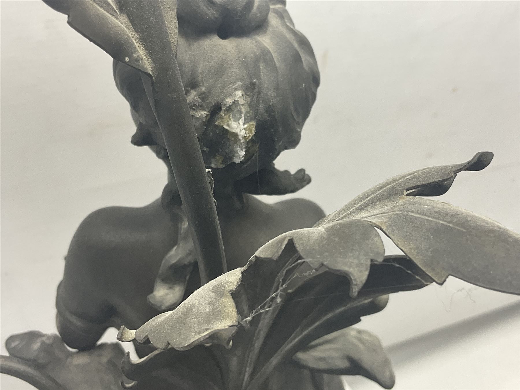 Pair of Art Nouveau style spelter figural table lamps, each mounted on rouge marble effect circular bases, with toleware flower heads and leafy decoration surrounding a female figure, H90cm