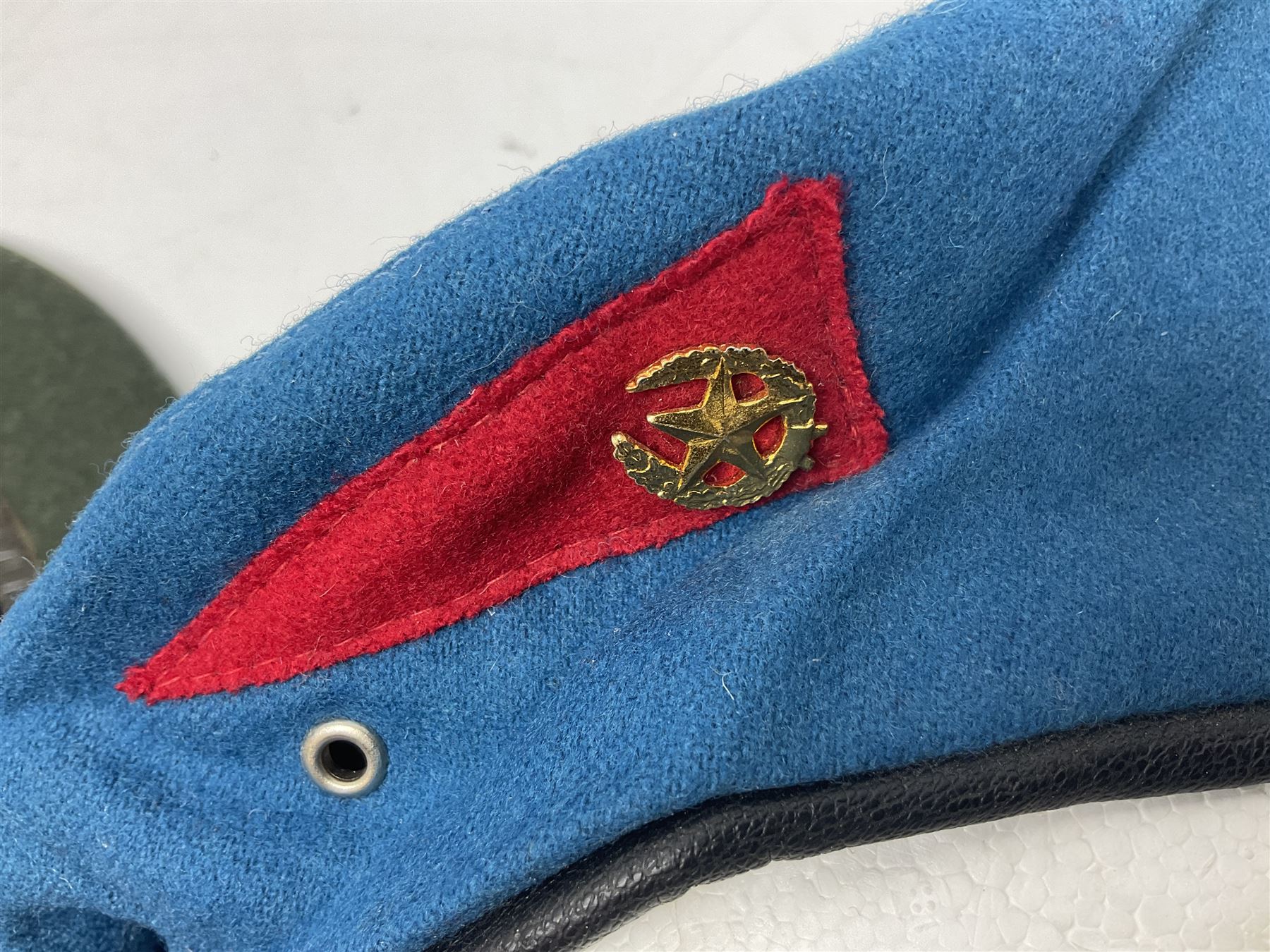 Four paratrooper berets - Russian, Italian, British and Foreign Legion; all with badges (4)