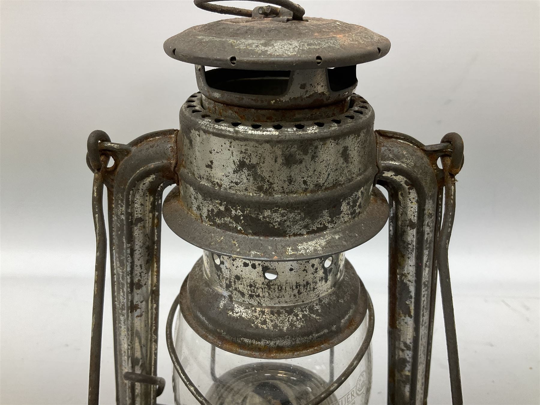 Copper and brass ship’s lamp marked ‘Anchor’, H25cm, Feuer hand storm lantern, Bialaddin Model 315 paraffin lamp and an Anchor lamp (4)