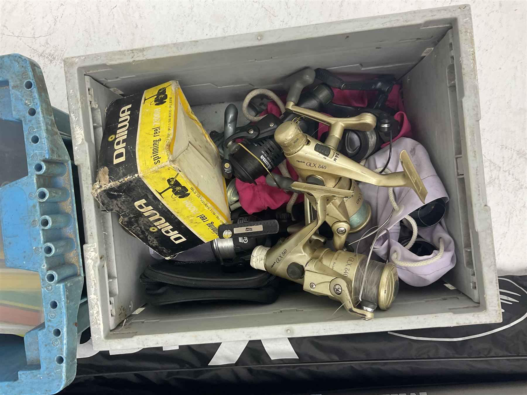 Fishing equipment, comprising reels to include Daiwa No.7300, boxed, Quick GLX 840, Quantum Heat BCS 350, okuma etc, together with various tackle, various poles, split canes and rods to include Middy Xtreme, Shakespeare Quo Carp, etc, many in bags