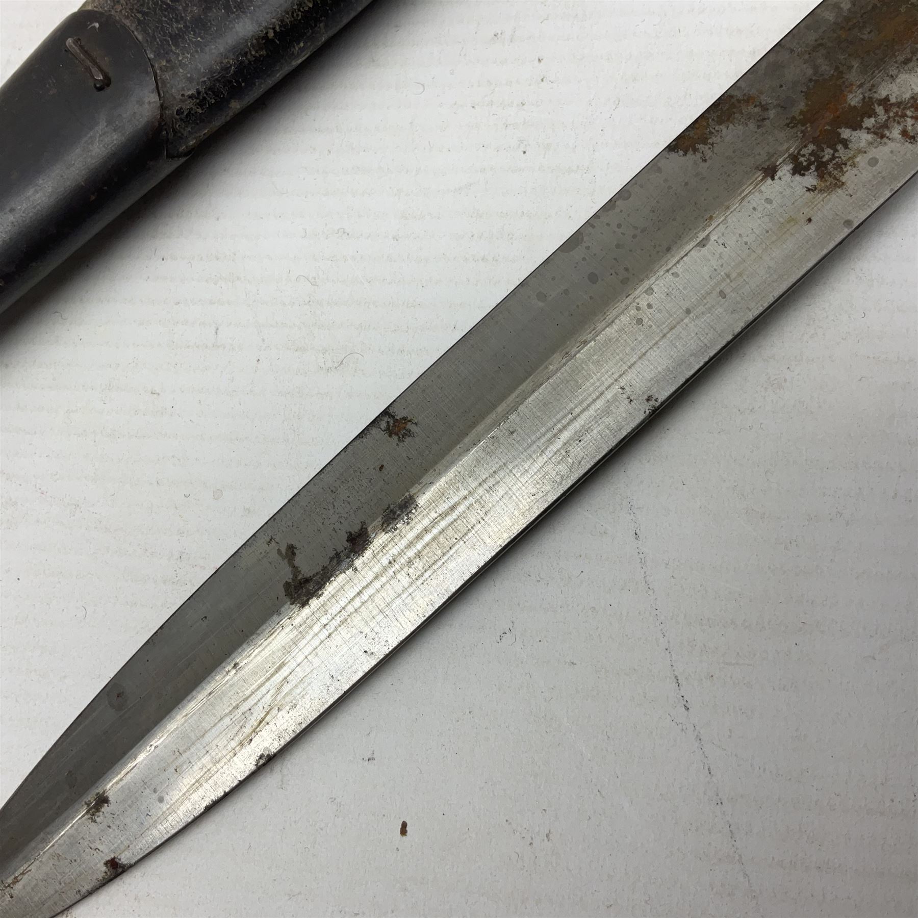 British Pattern 1888 knife bayonet, the 30.5cm double edged blade with raised central medial ridge; in leather covered scabbard L40.5cm overall