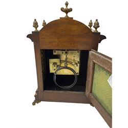 German - 19th century 8-day walnut bracket clock, striking the quarters on two coiled gongs, case with a break-arch top surmounted by cast brass finials, canted corners to the front with cast brass caryatids and sound frets to the sides, brass break arch dial with a silvered chapter ring, steel gothic hands, spandrels, and pendulum regulation dial. With pendulum.