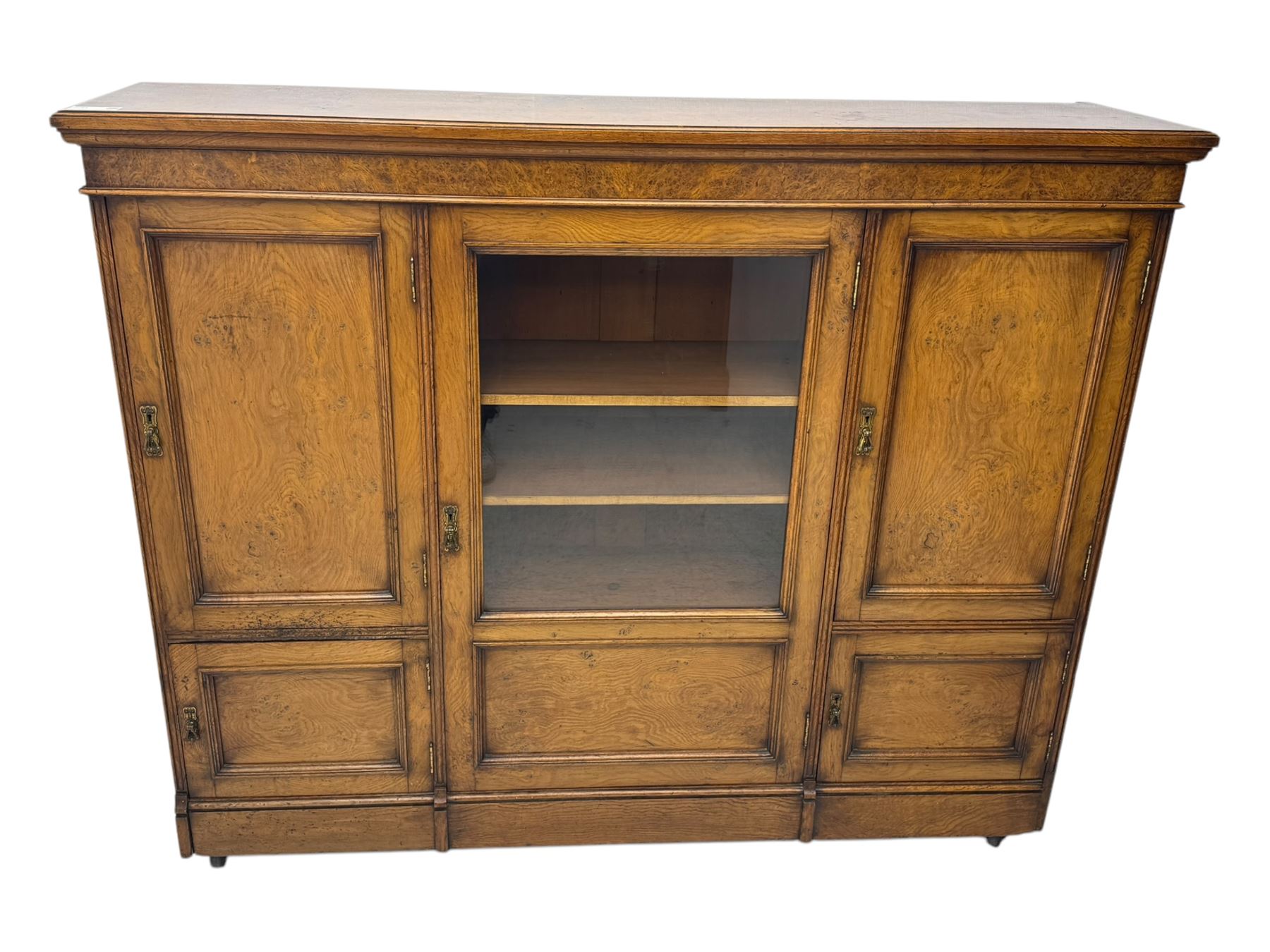 Late Victorian pollard oak bookcase or sideboard, the central glazed door opening to reveal adjustable shelves and interior makers label 