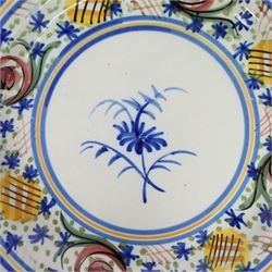 Pair of 20th century Spanish tin glazed polychrome plates, each painted with central foliate spray, within a stylised border, D32cm 