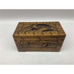 Three Oriental boxes comprising Camphor wood example carved with figures in a scene surrounded by border carved with leaves and flowers, another similar smaller Camphor wood example and further box with carved palm tree design, all with brass fittings (3)