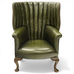 Georgian design green leather barrel-back wingback armchair, pleated upholstered back with shaped wings over scroll arms and sprung-seat, close nailed border, raised on cabriole supports terminating in pad feet
