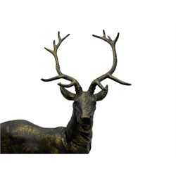 Pair bronzed cast iron life-size garden or indoor stags with raised heads, on oval plinth base