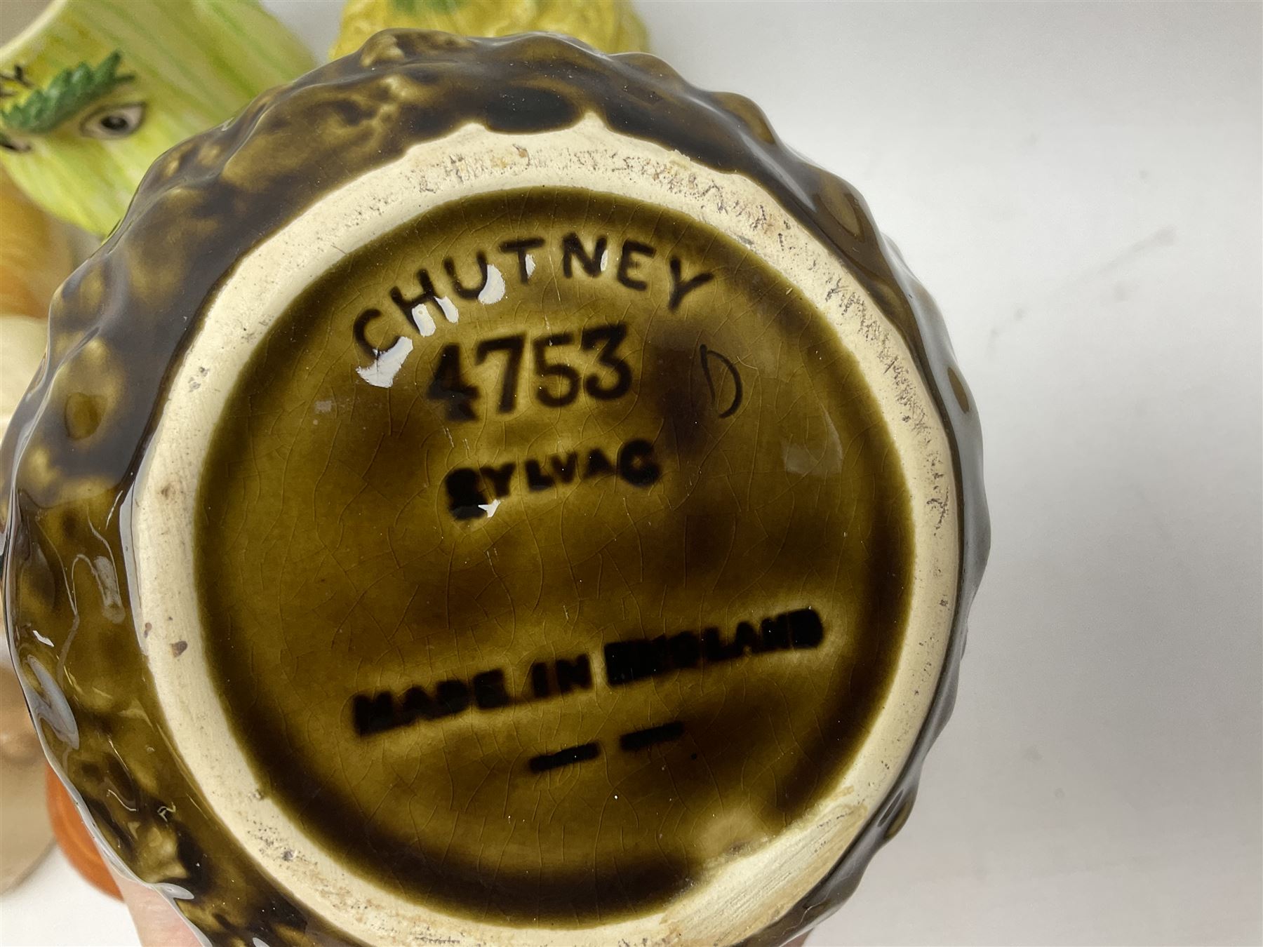 Collection of mostly Sylvac kitchen storage jar face pots, including piccalilli, chutney, tomato and bread sauce, tallest H15.5cm