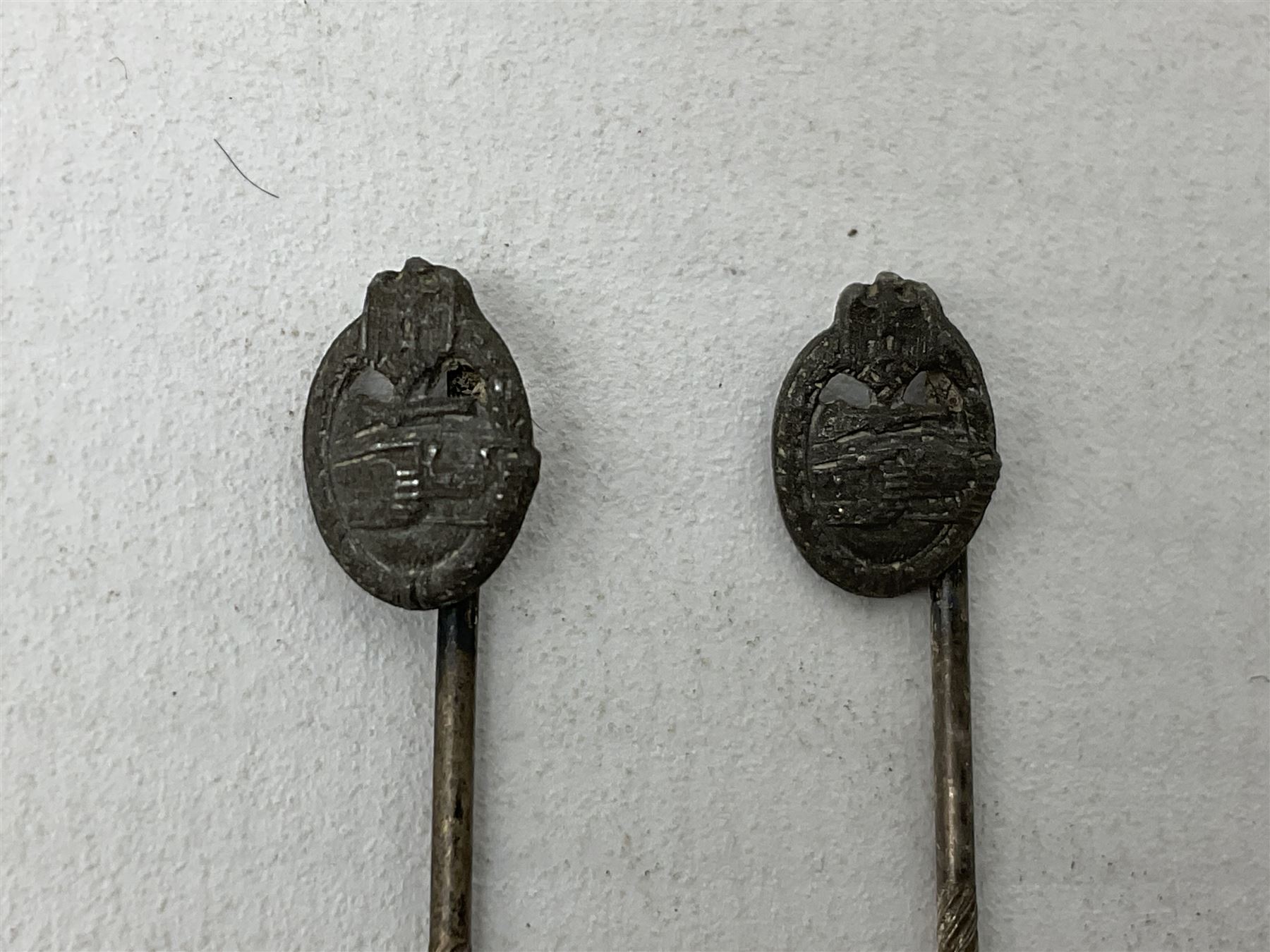 Nine WW2 German lapel pins including five Infantry Assault, Tank