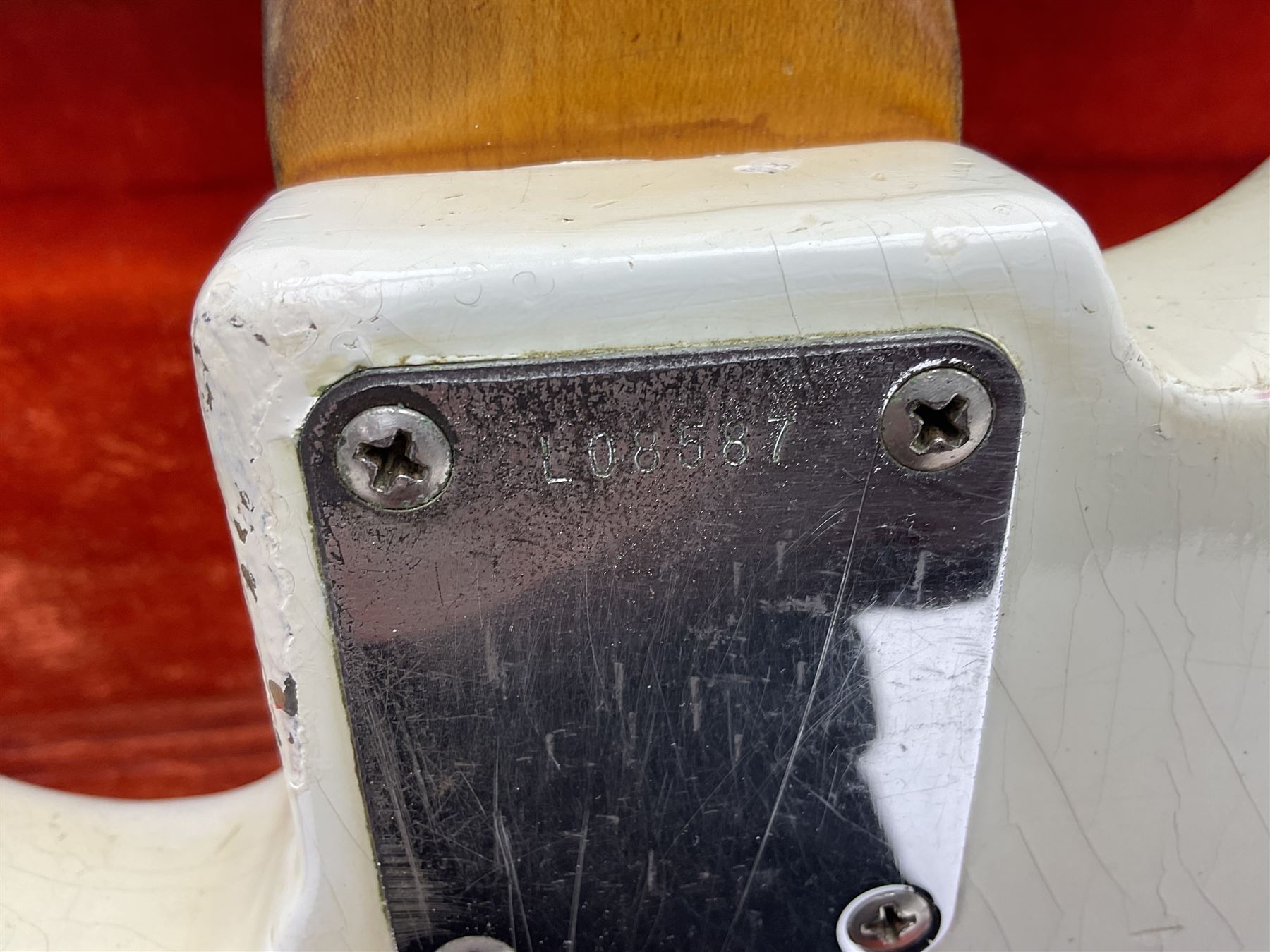 1963 Fender Jazz three-knob bass guitar; impressed with date code 7AUG63A on end of neck and serial no.L08587 on back plate; all original but re-finished in white in the 1970s; sold with photographs of the instrument in the 1960s with original finish and in the 1970s re-finished; L117.5cm; in original hard carrying case; Provenance: the professional guitar of Howard Livett from new to his death in 2005. Howard played in The Humperdincks, the backing group for Englebert Humperdinck, also played in the backing group for Max Bygraves and in the band Hedgehoppers Anonymous. The guitar is also sold with a manuscript letter of provenance from Howard's wife.