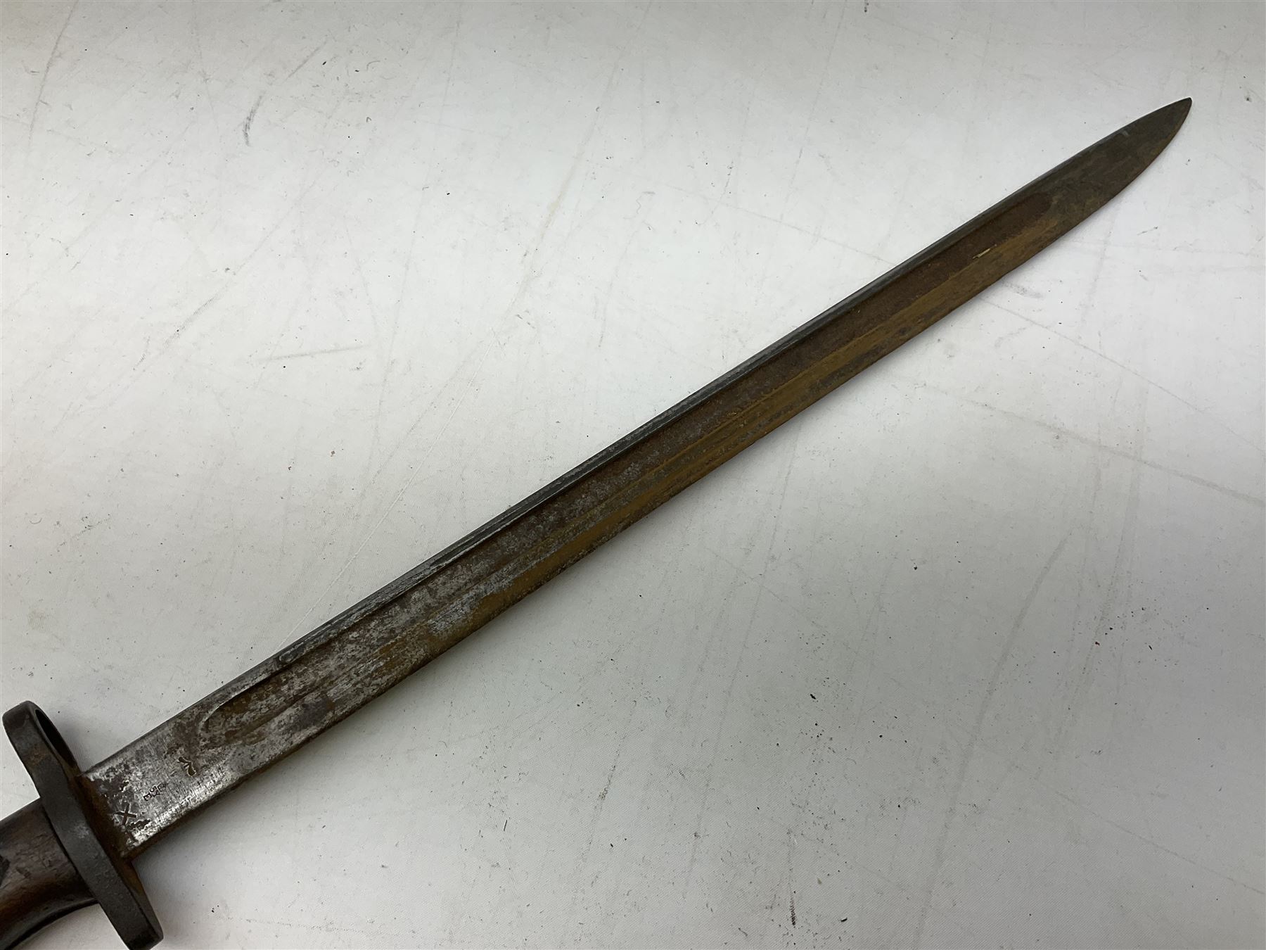 British Pattern 1907 bayonet with 43.5cm fullered steel blade; in leather scabbard with webbing frog L58cm overall; another Pattern 1907 bayonet lacking scabbard; and British Pattern 1888 Mk.I bayonet by Wilkinson London (no scabbard) (3)
