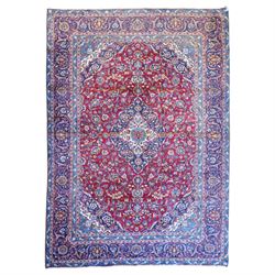 Central Persian Kashan hand-knotted carpet, crimson field with a central elaborate cusped ...