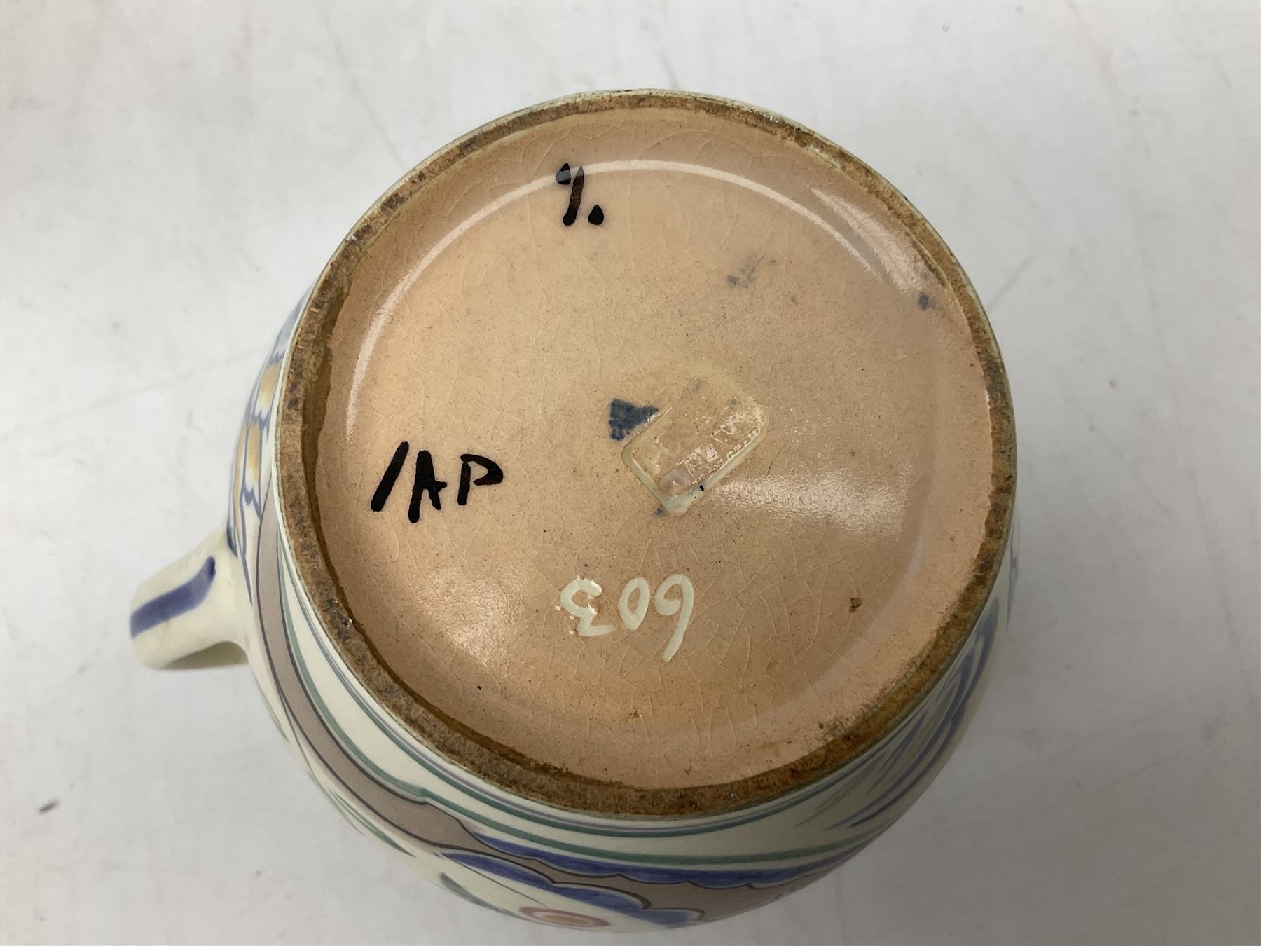 Early 20th century Poole jug, decorated with flowers in purple, blue