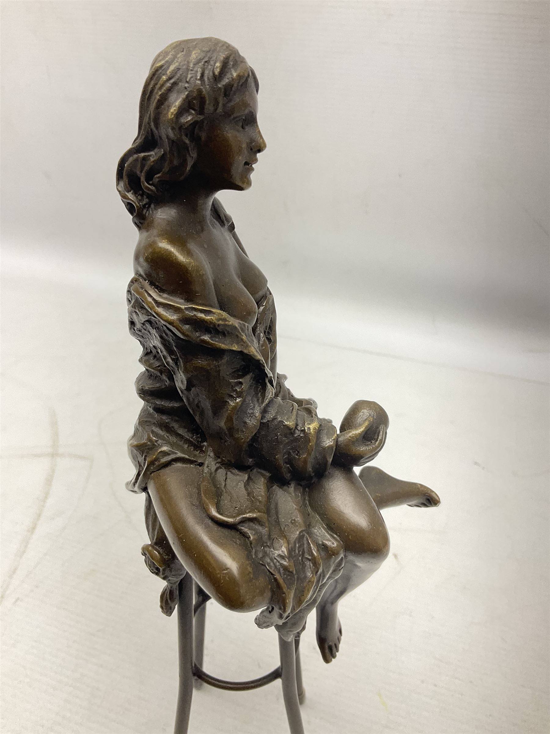 Art Deco style bronze modelled as a female figure seated upon a chair holding an apple, after 'Pierre Collinet', H28cm
