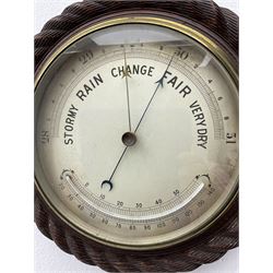 Edwardian - 8-day ships bulkhead clock and an Aneroid barometer.
In matching circular oak cases with carved rope twist bezels.
Clock with a painted metal dial, Roman numerals, minute track and steel spade hands, small seconds hand and platform regulation. Case 9