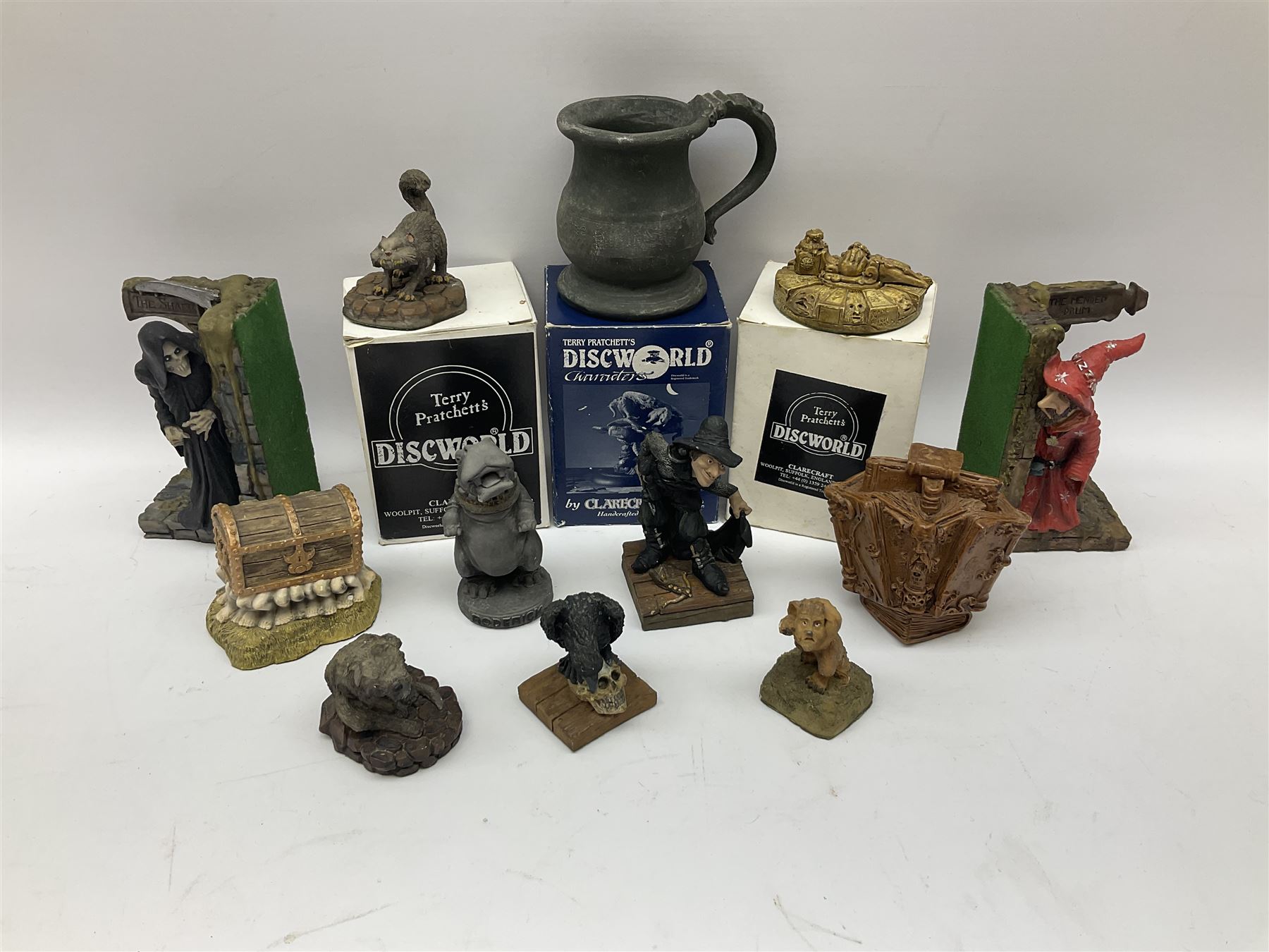 Terry Pratchett Discworld figures, comprising Roderick the hippo, DWE2, a 1995 event piece, Rincewind bookend, DW11, Death bookend, DW12, Librarians wizard knob, boxed, DW55, the luggage, boxed, DW04, tankard from the mended drum, DW21, Teppic the assassin, DW32, Greebo, DW45, Herne the hunted, DW64, Gaspode,  DW31, Quoth on skull, DW49 and Dibbler's compass DW16. 