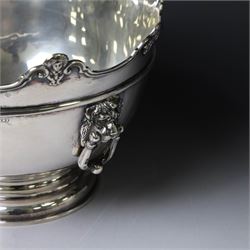 Edwardian silver Monteith punch bowl, the scalloped rim with strapwork and figural decoration, with two lion mask mounted ring handles, upon a circular stepped foot, hallmarked London 1903, maker's mark worn and indistinct, H15cm, D23cm