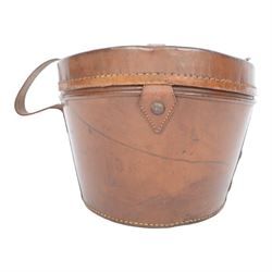 Bowler hat, by Moores, with retail label for Kendall of Scarborough, with brown leather top hat box having a handle to the lid and buckle fastening, lined in red velvet, marked W.B. to the front 