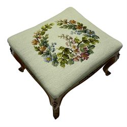 19th century French walnut dressing stool, rectangular seat upholstered in a floral needlework tapestry top, shaped apron with applied carved flower heads, on cabriole supports with acanthus carved feet