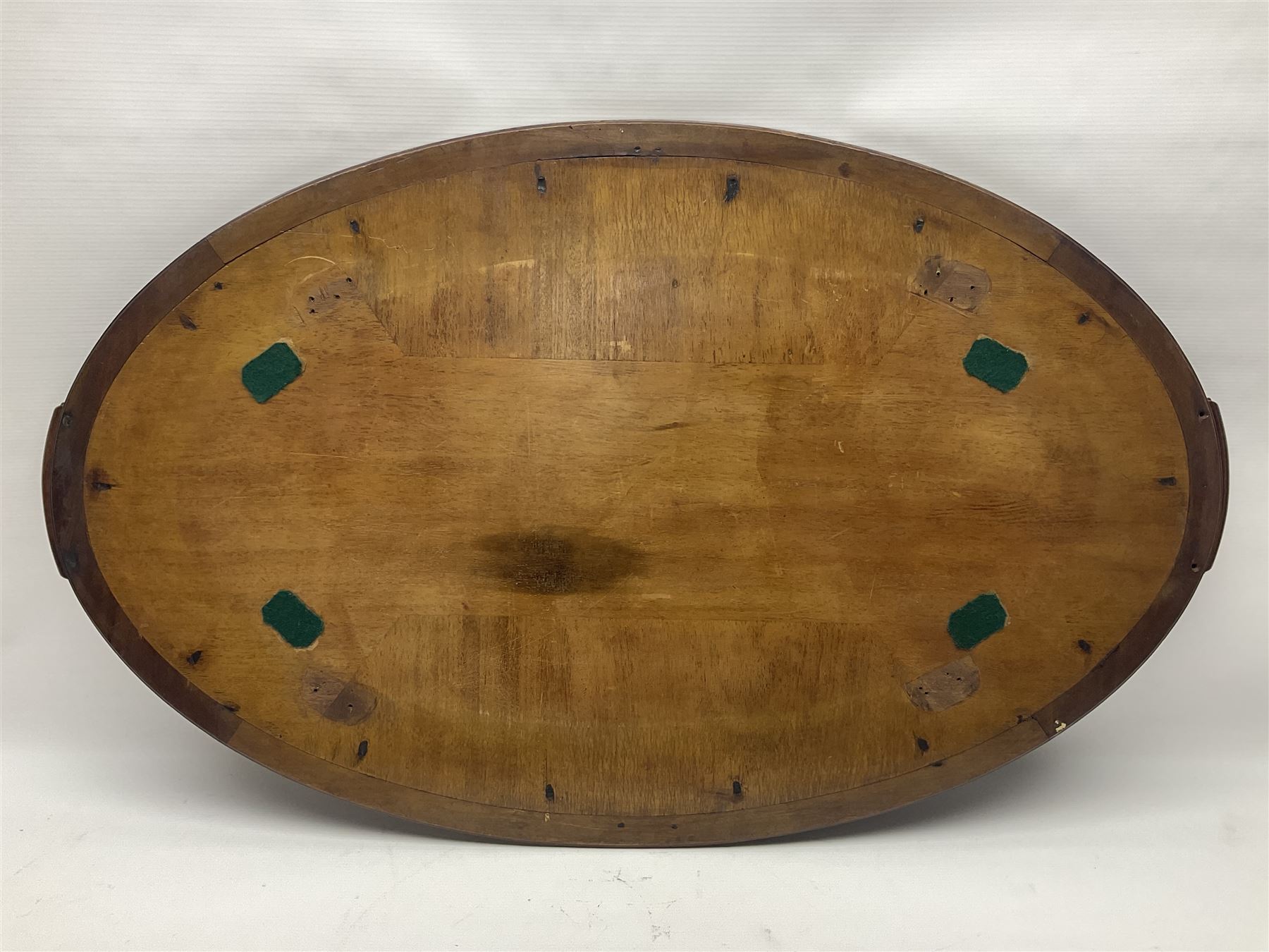 Late 19th/early 20th century mahogany and marquetry inlaid tray, of oval form with twin scrolled handles and moulded border, the central panel inlaid with figures seated at a table drinking tea, L99cm