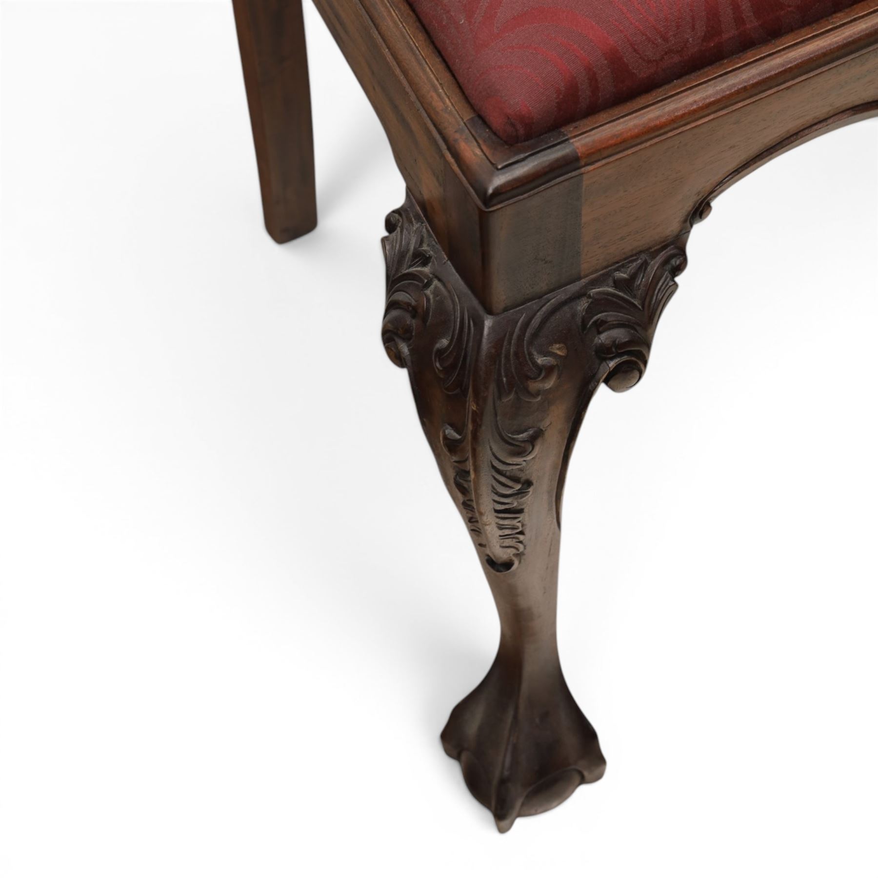 Chippendale design set of ten (8+2) mahogany dining chairs, serpentine cresting rails with carved detail over pierced ribbon-tied splats, red damask upholstered drop-in seats, on cabriole supports with acanthus carved knees and claw and ball feet