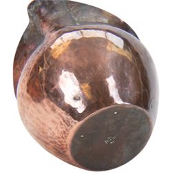 Keswick School of Industrial Arts: Arts & Crafts copper teapot, of stylised squat form with cane bound reed handle and ebony finial, together with a lidded jug, of bellied form with cane bound handle and Bakelite type thumbpiece and a cream jug of squat form with stylised loop handle, all stamped KSIA beneath, tallest H14cm