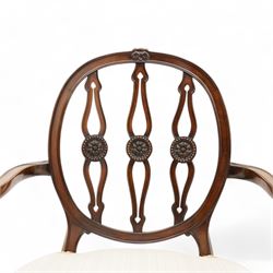 Set of six (4+2) late 19th to early 20th century Hepplewhite design mahogany dining chairs, moulded oval framed back with three shaped and pierced upright rails decorated with floral carved roundels, upholstered in pale fabric, on square tapering supports with recessed panels and block feet 