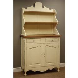  Laura Ashley rustic cream painted and mahogany dresser, raised shaped back with two shelves, two drawers and two cupboards to base, W107cm, H193cm, D43cm  