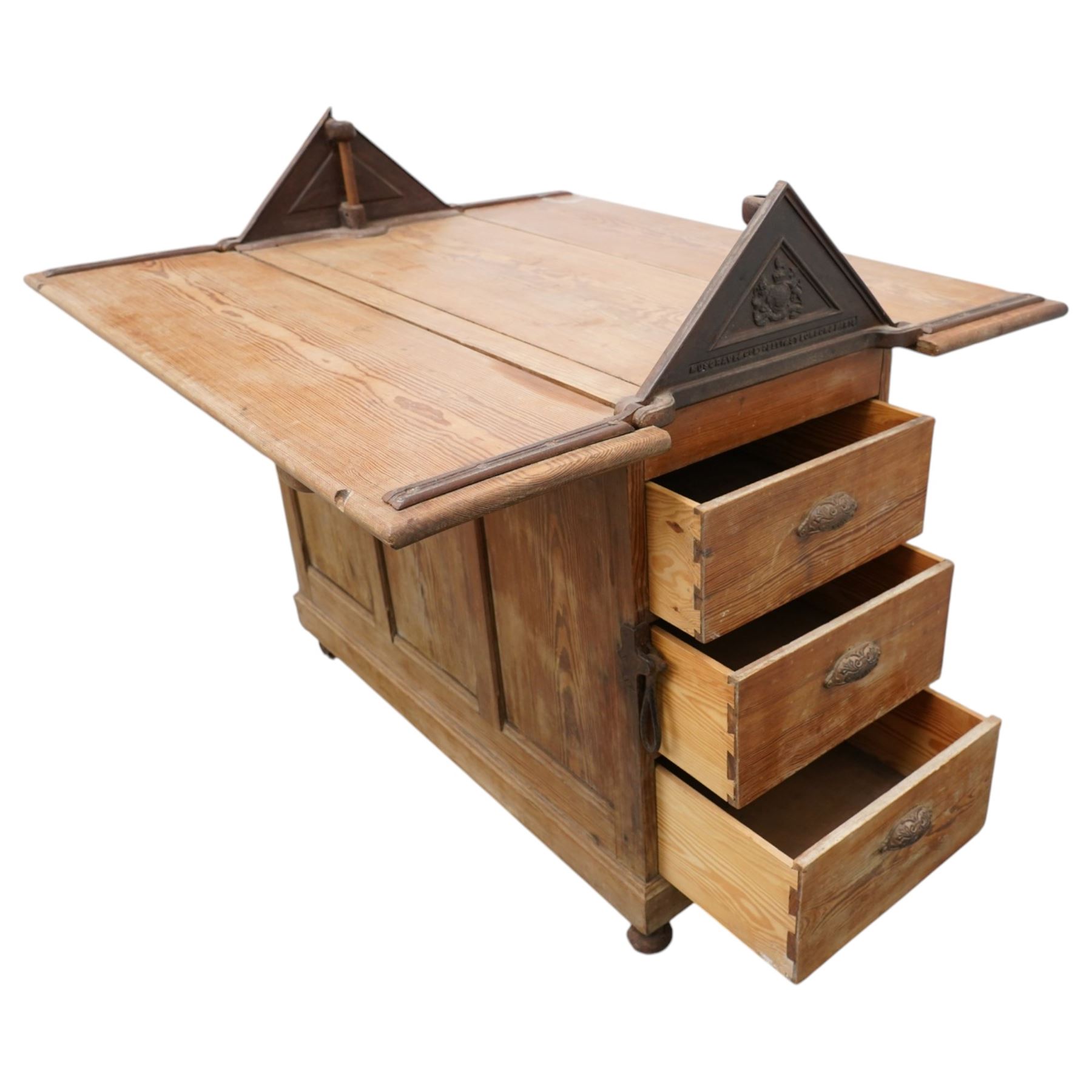 Musgrave & Co Ltd (Belfast) - late 19th century pine saddle horse, with three drawers to one end and cupboard door to the other, the hinged top opening to form a table, the cast iron plaque bears the Royal coat of arms and maker's name