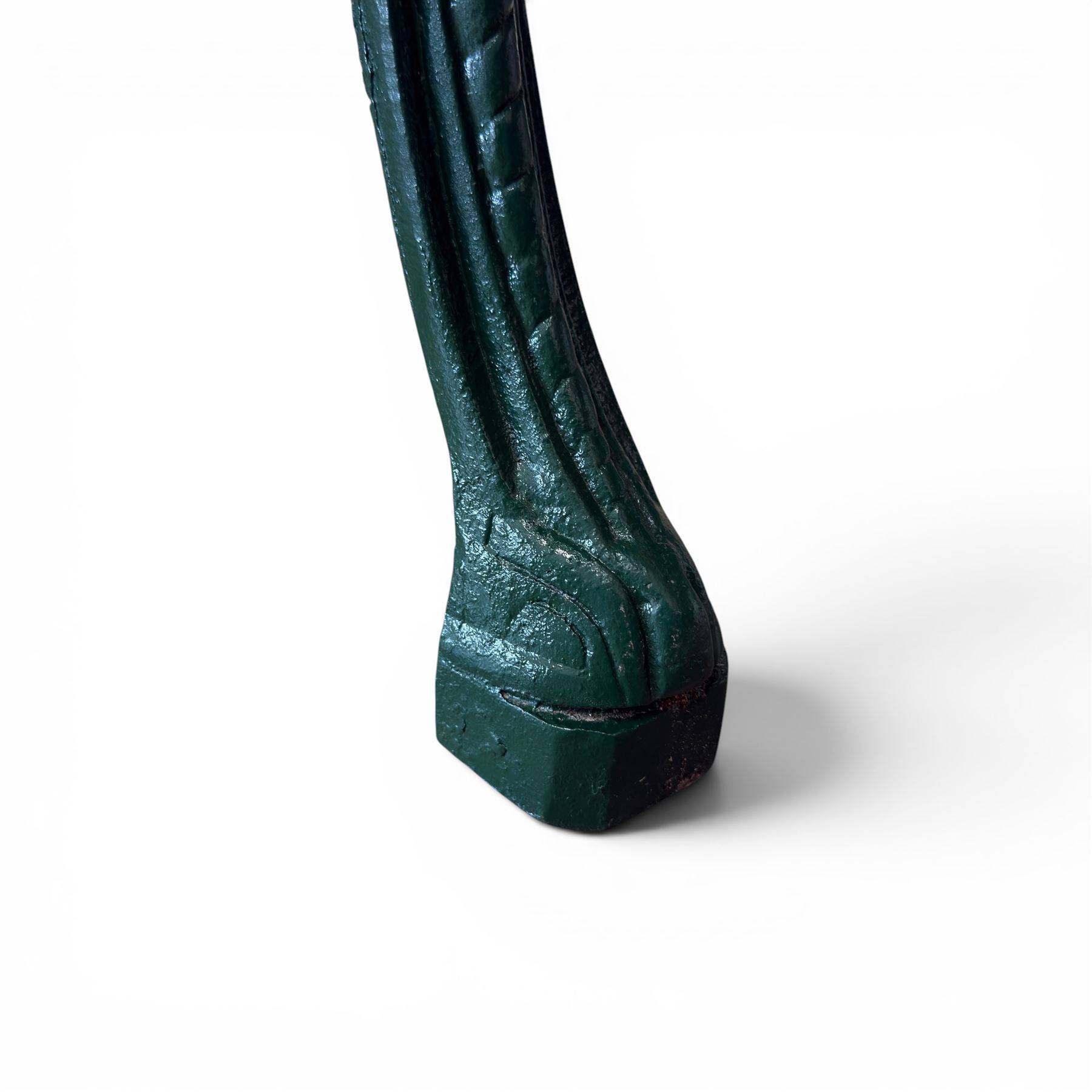 Painted cast iron garden table, the circular pierced top with foliate decoration and egg-and-dart rim, raised on three cloven hoof supports with classical female mask knees, united by pierced undertier, in green-painted finish