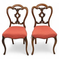 Set of four Victorian walnut balloon back chairs, with a carved and pierced back splat with foliate scrolls, serpentine seat upholstered in a diamond pattern fabric, raised on cabriole legs 