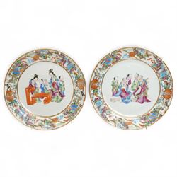 Pair of Chinese Canton famille rose plates, decorated to the border with goldfish books an...