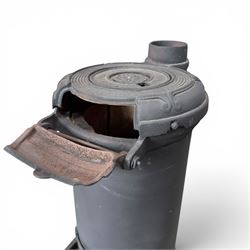 Late Victorian cast iron stove of small proportions, decorated with scrolls and central rosette to the top