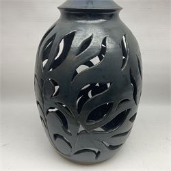 John Egerton (c1945-): studio pottery stoneware lamp base, decorated with pierced floral decoration with a dark blue ground, together with Edinbane Pottery plant stand and two other studio pottery items, lamp base H56cm