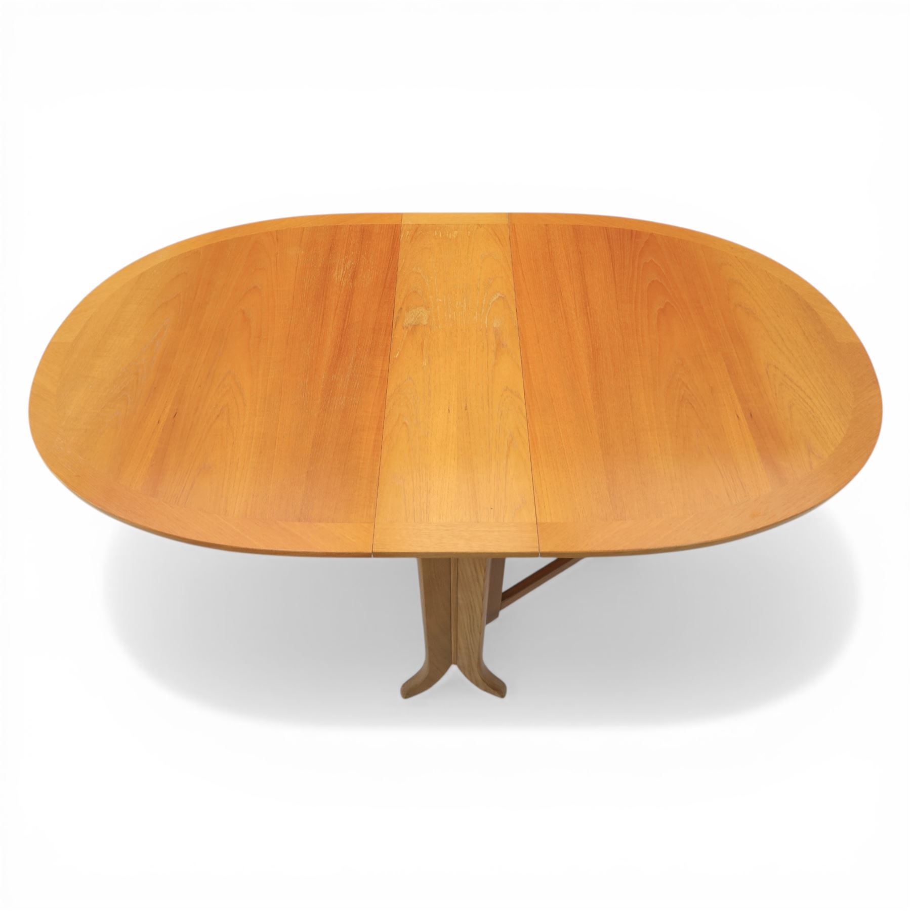 Nathan - teak drop leaf dining table and four Nathan dining chairs, the rectangular top with rounded corners fitted with twin hinged drop leaves and gate legs, extended to form an oval table 174cm in length, raised on square section supports united by stretchers, the chairs with teak frames and padded beige upholstered seat (H 96cm, W 48cm)