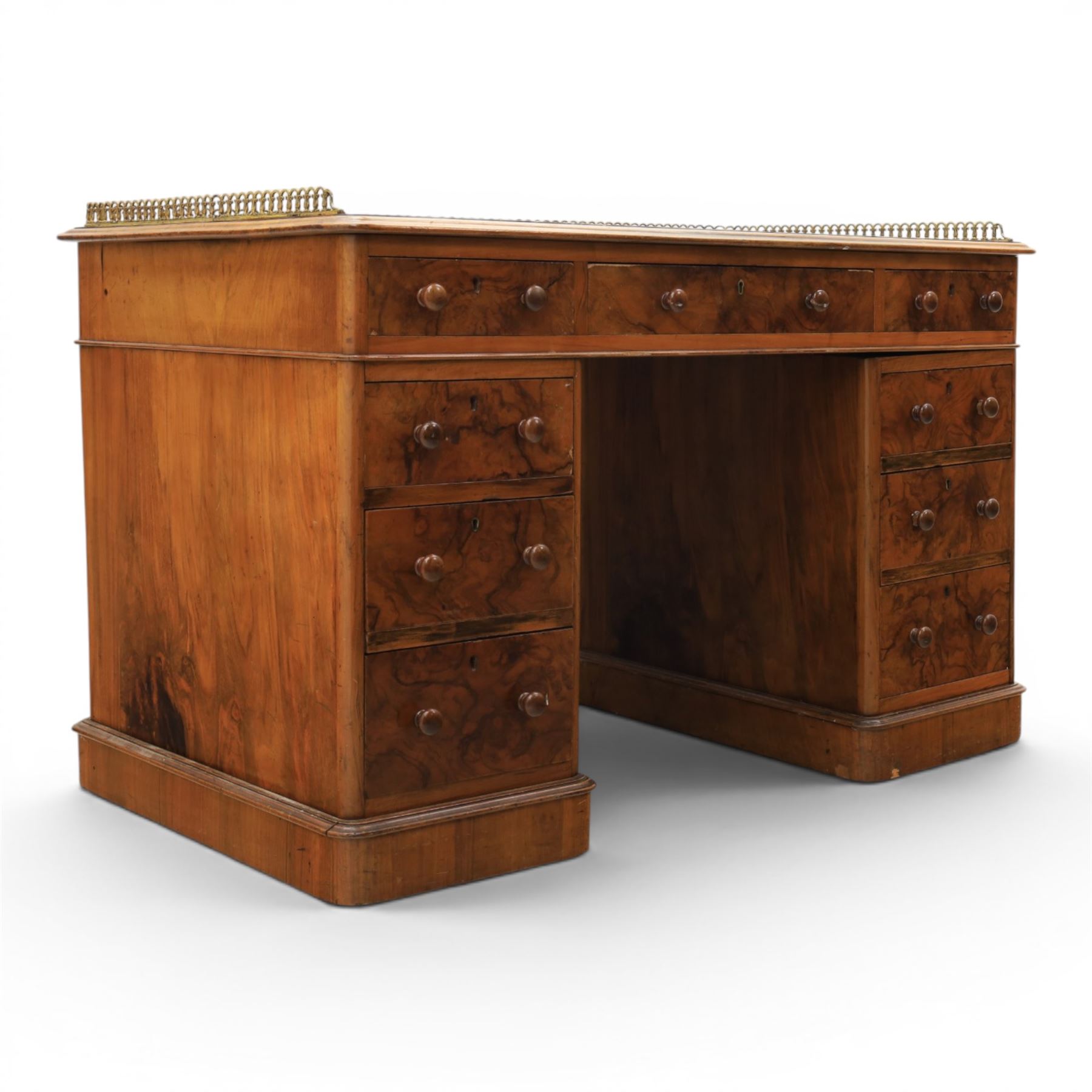 Victorian figured walnut twin pedestal desk, brass galleried top with inset tooled green leather writing surface, above three frieze drawers, raised on two pedestals with three drawers, on plinth bases above castors