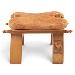 20th century Camel stool, tan leather seat with tooled design, raised on a light wood carv...