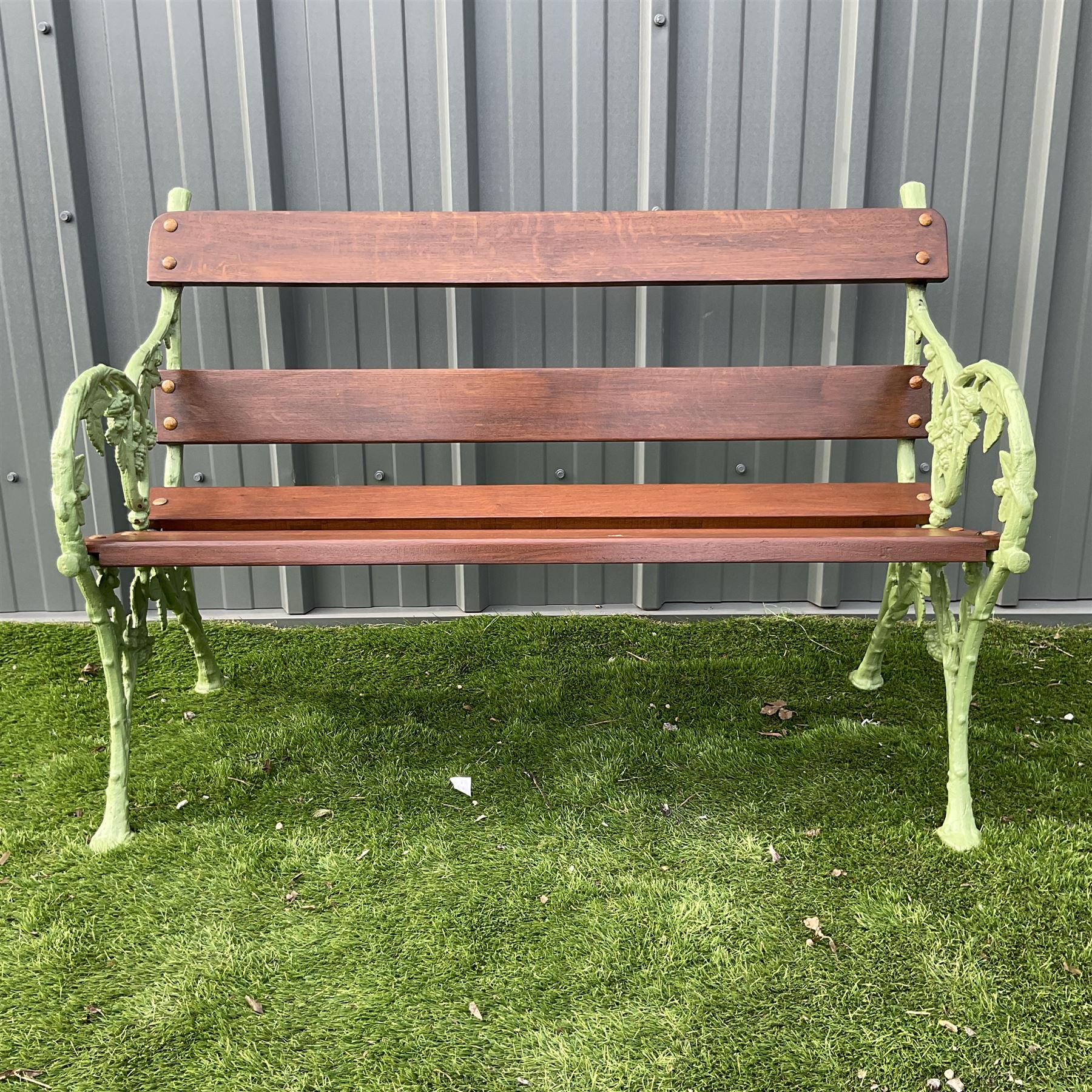 Green painted cast iron and wood slate bench decorated in grapevine - THIS LOT IS TO BE COLLECTED BY APPOINTMENT FROM DUGGLEBY STORAGE, GREAT HILL, EASTFIELD, SCARBOROUGH, YO11 3TX