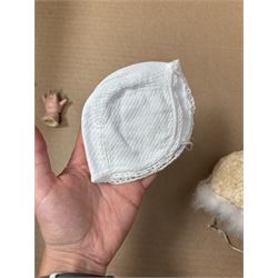 Two German bisque head dolls, to include a Franz Schmidt example with blue glass eyes and an Armand Marseille 590 example with applied hair, together with a Schoenau & Hoffmeister bisque doll's head, pair of doll's hands and a collection of clothing