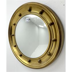 Small circular brass finished frame convex wall mirror 