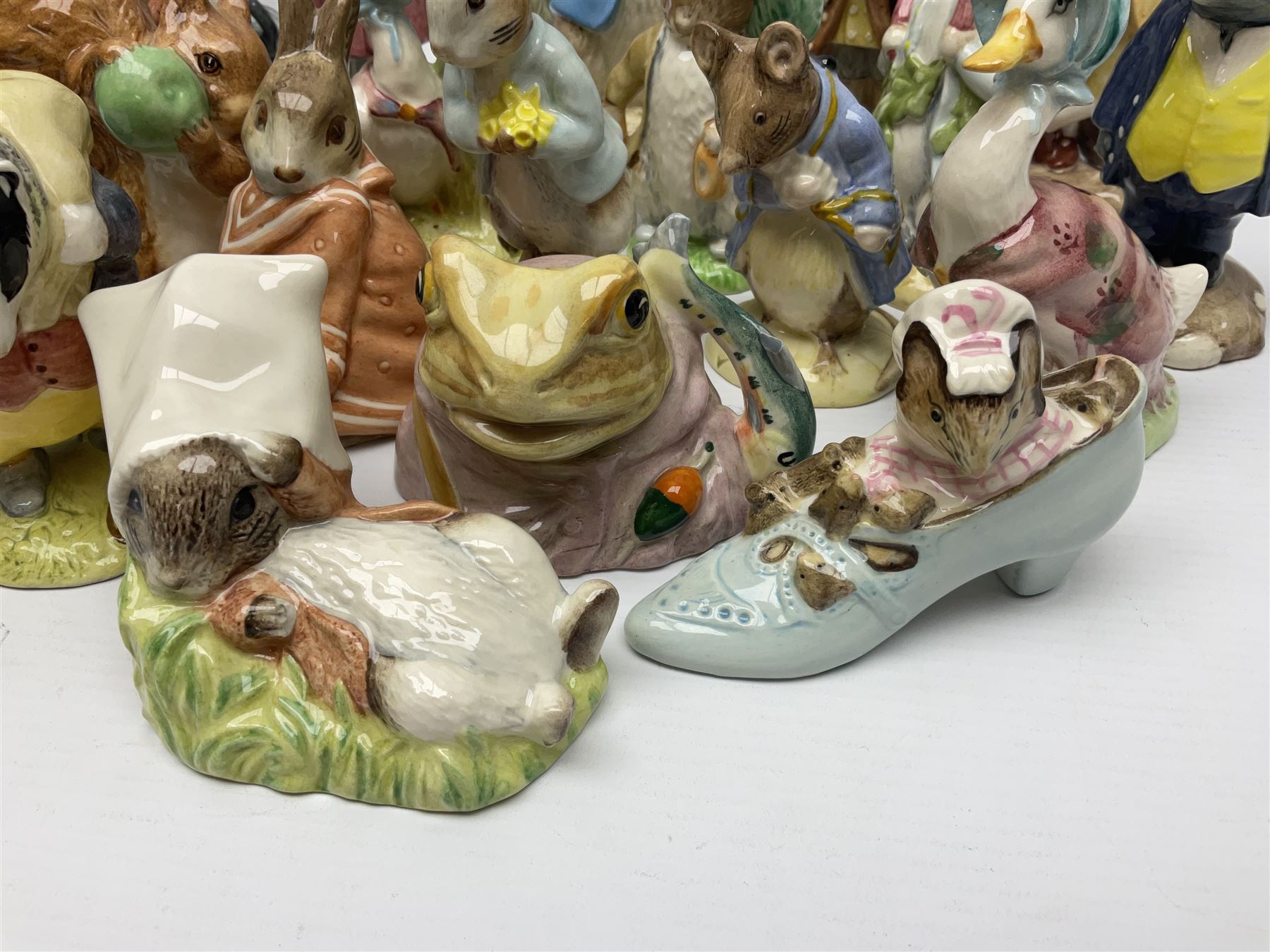 Sixteen Royal Albert Beatrix Potter figures, including Poorly Peter Rabbit, Jemima Puddle Duck and Squirrel Nutkin etc, all boxed together with a Beswick Beatrix Potter Jeremy Fisher miniature jug and four Beswick Wind in the Willows figures 