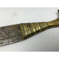 Sudanese arm dagger with 40cm steel double edged blade and decorative pierced brass hilt; in tooled leather scabbard with arm loop and ornate brass mounts L56cm overall