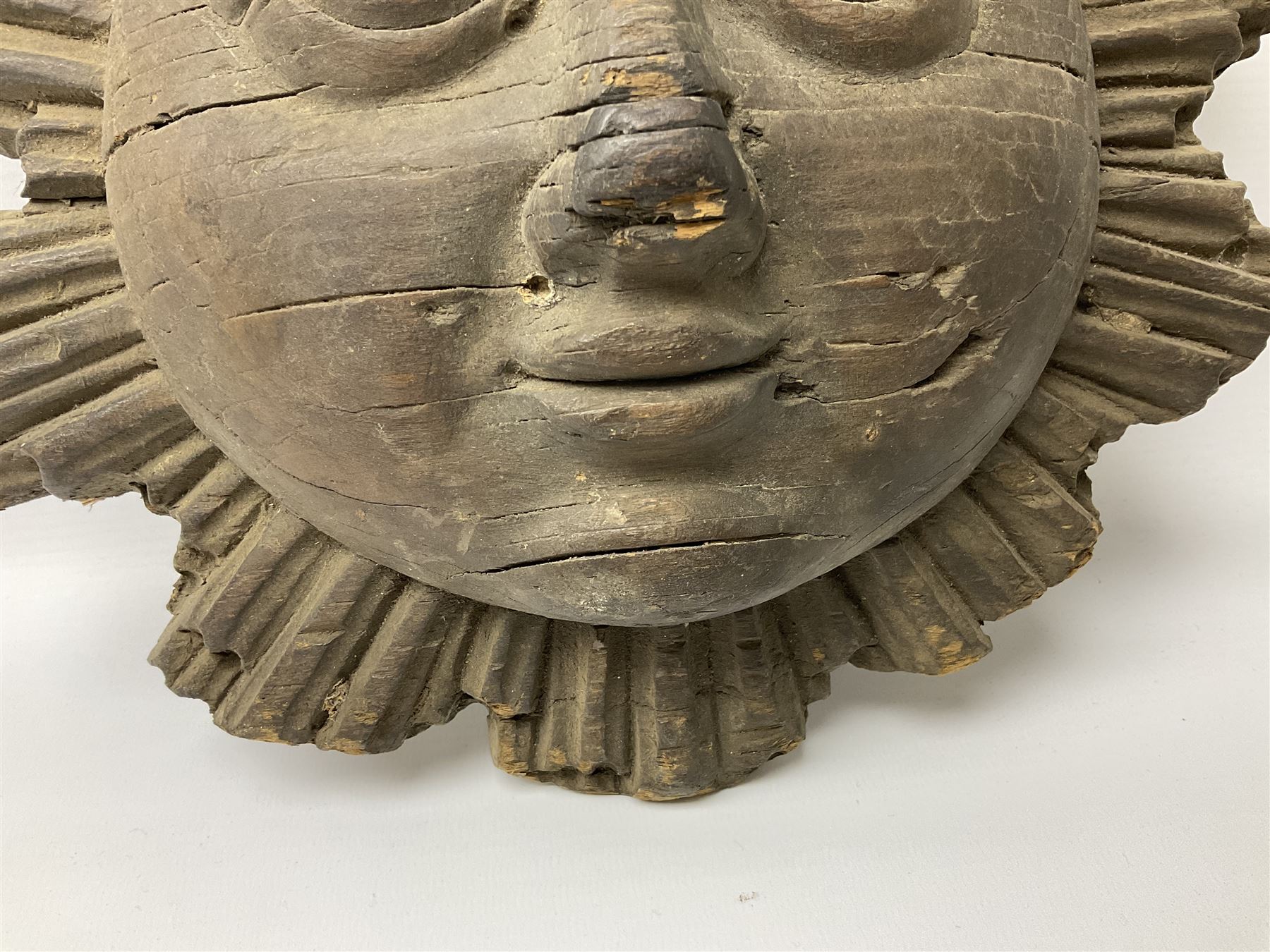 Carved pine mask of the sun, probably late 17th/early 18th century, originally a cresting, bearing Christie's lot labels, D20cm

Provenance 
Lot 161, Christopher Howe - The First Twenty Years, Christie's. 24th March 2004
