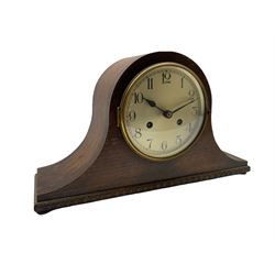 German 8-day mantle clock in an oak veneered case, striking the hours and half hours on a gong.