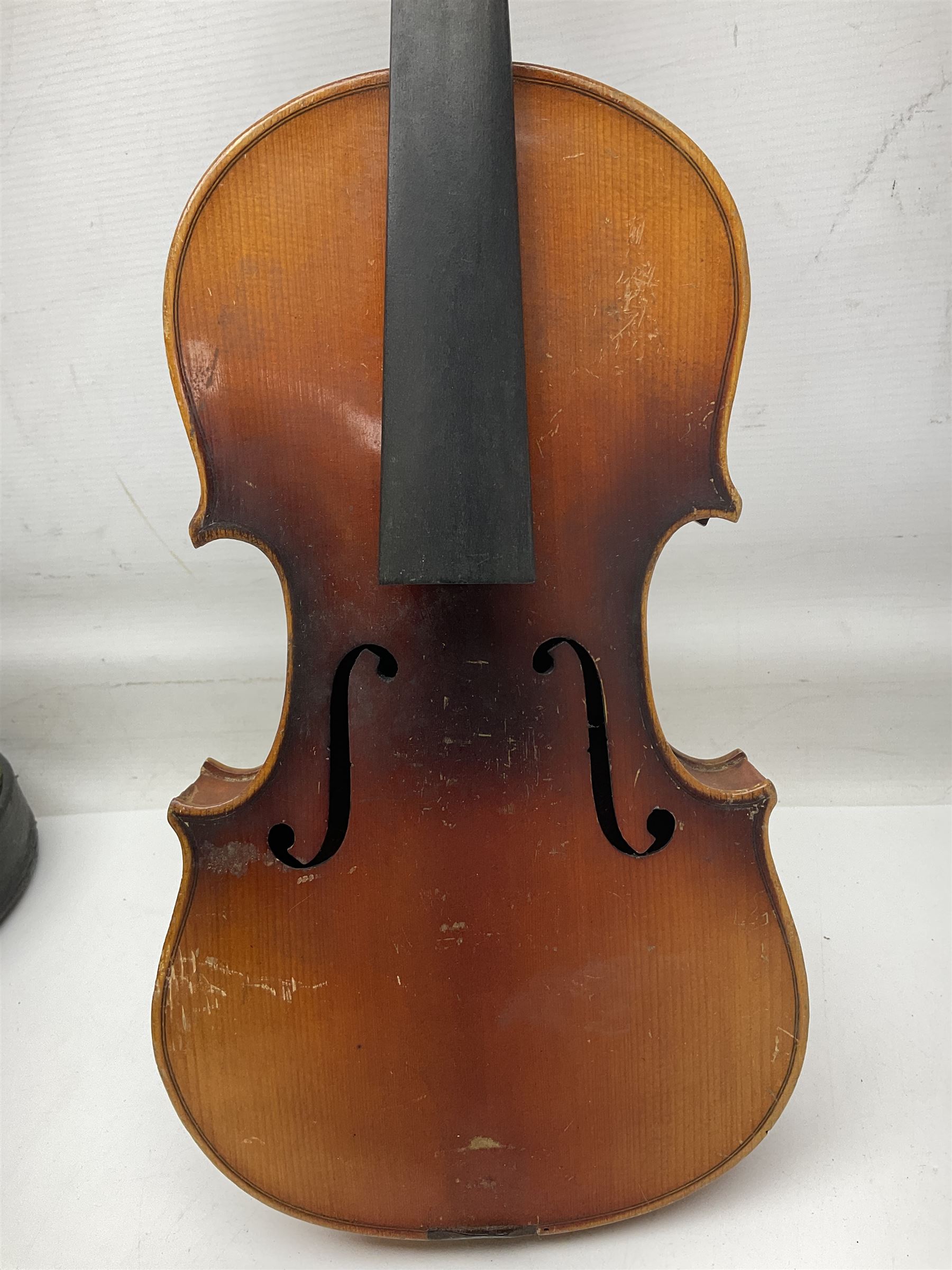 Czechoslovakian violin c1920 with 36cm two-piece maple back and ribs and spruce top, bears label 'Copy of Antonius Stradivarius Made in Czechoslovakia' L59cm; in carrying case; 1950s Czechoslovakian violin; and 195os Czechoslovakian three-quarter size violin; both cased (3)